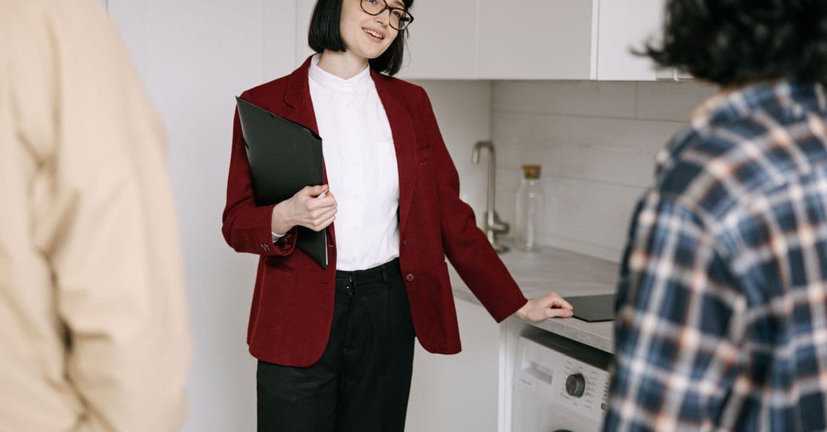 A real estate agent showing a modern apartment to prospective clients.